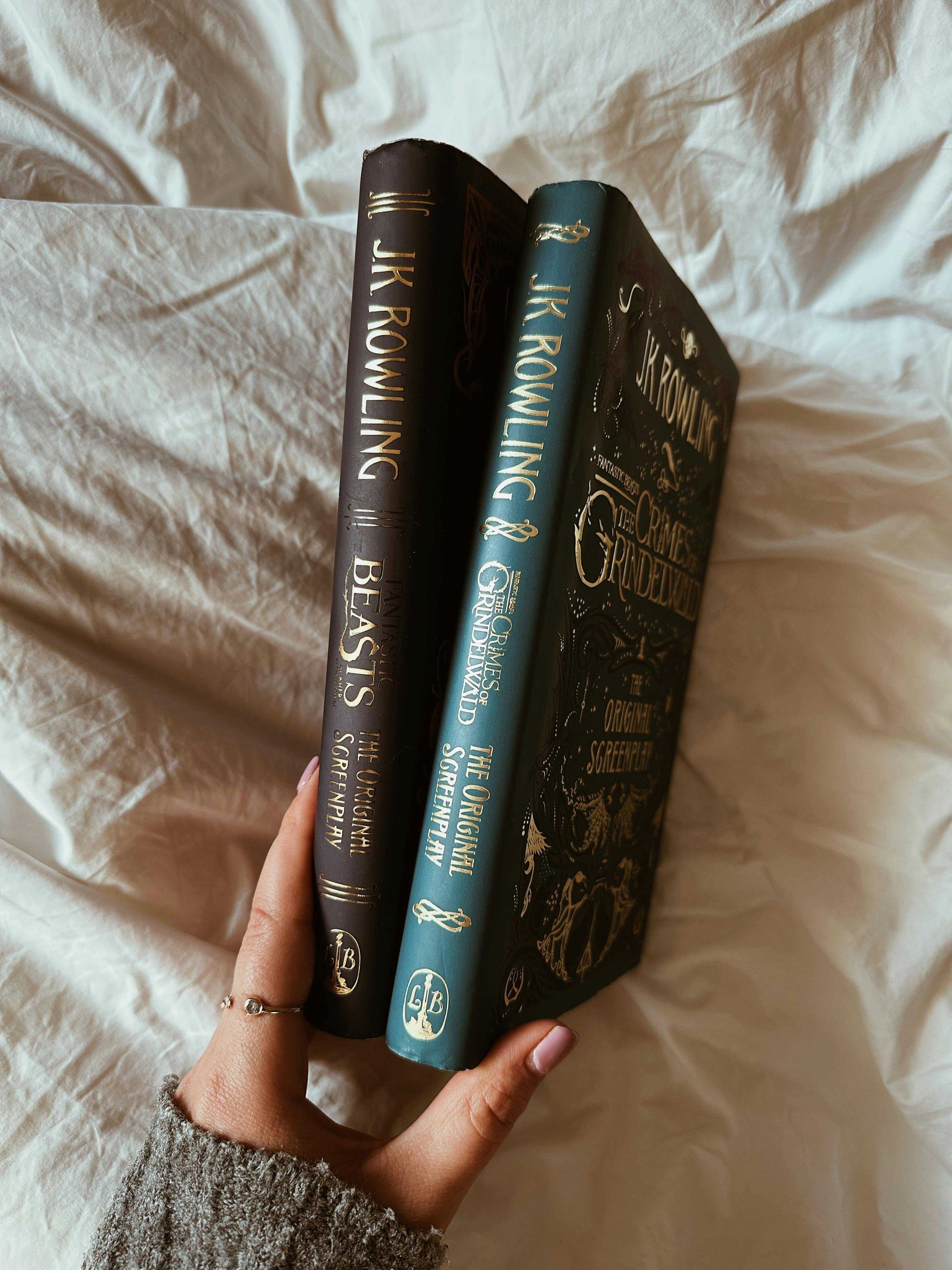 Hand holding fantasy books